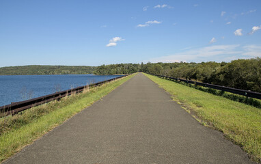 ashokan reservoir promenade surface next to large pond body of water and catskills mountains in the background (public park leisure, walking biking path trail) sunny day travel hudson valley new york