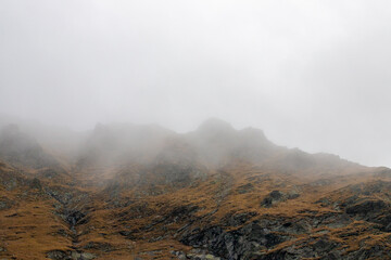 The ridge of a mountain in the fog. Mountain peak in the clouds