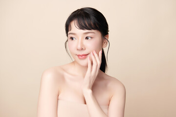 Beautiful young asian woman with clean fresh skin on beige background, Face care, Facial treatment, Cosmetology, beauty and spa, Asian women portrait.