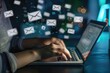 © Alexei - A person is typing on a laptop with envelope icons coming out of the screen