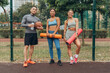 © Maria Vitkovska - Group of smiling, multinational man and women holding fitness mat, bottle training outdoors