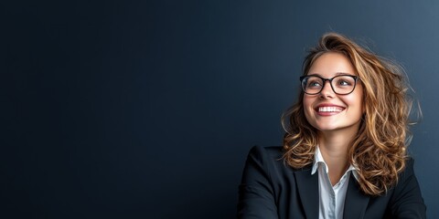 Young, happy, cheerful, professional business-woman. Happy, laughing female office worker wearing glasses looking away at copy space