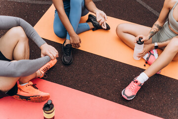 top view, athletes sitting on yoga mat, relaxing on the street, outdoors. sport, motivation concept