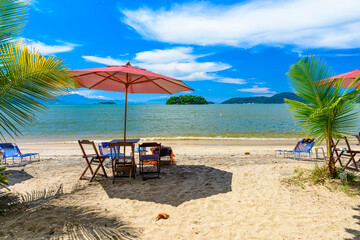 Wall Mural - Jabaquara beach with umbrella and chairs in Paraty, Rio de Janeiro, Brazil. Paraty is a preserved Portuguese colonial and Brazilian Imperial municipality