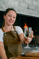 Wall Mural - Smiling woman toasting with a glass of wine