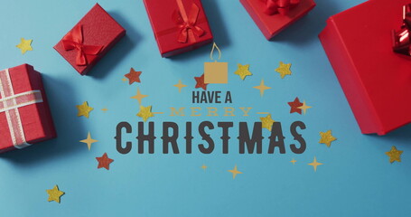 Poster - Image of have a merry christmas text over christmas decorations and gifts on blue background