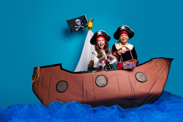 Canvas Print - Full size photo of two small kids halloween pirate costume sail ship treasure hunt isolated on blue color background