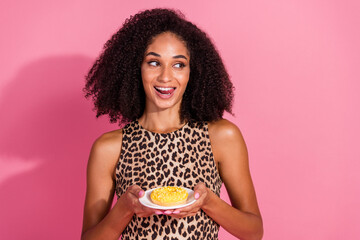 Poster - Photo portrait of lovely young lady look empty space hold donut dressed stylish leopard print garment isolated on pink color background