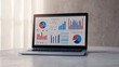© Lale - Laptop Screen Showing Financial Charts and Graphs for Business Analysis