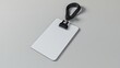 © pvl0707 - A clean white name tag with a blue lanyard resting on a smooth gray surface in a serene and professional setting