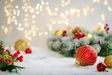 Wall Mural - christmas holiday background with snow, fir tree and decorations with christmas light behind. christ