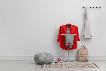 Sticker - Coat rack, pouf, backpack, clothes and shoes in hallway. Space for text