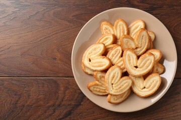 Wall Mural - Delicious sweet palmier cookies on wooden table, top view