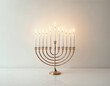 © David Angkawijaya - a golden menorah with candles lit up on it on a white surface
