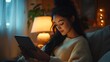 © cynz - A woman with long, sleek black hair in a high ponytail, balancing her work schedule on a tablet while sitting in a cozy living room. The warm lighting from a nearby lamp creates a peaceful, inviting