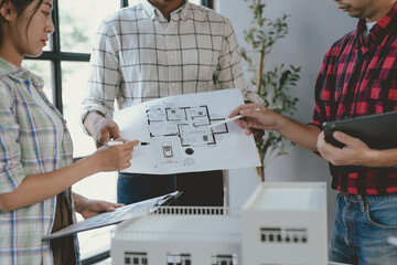 Wall Mural - architects collaborating in office, discussing new house plan project surrounded by blueprints, draw