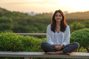 Young woman meditating in a park at sunset with soft golden light filtering through the trees symbolizing mindfulness inner calm and harmony with nature in a serene setting