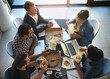 © C.Arcurs/peopleimages.com - Creative, agency and business people in meeting with fast food, planning and collaboration from above. Eating, computer and team in workshop for development report, growth and data analysis in office