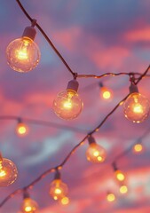 Colorful twilight sky with glowing light bulbs hanging above an outdoor setting