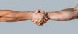 © Yevhen - Friendly handshake, friends greeting, teamwork, friendship. Close-up. Rescue, helping gesture or hands. Strong hold. Two hands, helping hand of a friend. Handshake, arms friendship