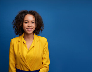 Studio Portrait of Beautiful Happy Young Woman Smiling Against Blue Studio Background Confidently