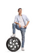 © Ljupco Smokovski - Full length portrait of a young man stepping on a car tire
