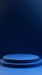 © Maria Mikhaylichenko - Minimalist blue circular podium against a deep navy background, creating a sleek and modern display platform for product showcasing.