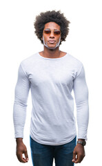 Wall Mural - afro american man wearing sunglasses over isolated background with serious expression on face. simpl