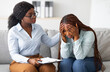 © Prostock-studio - Upset black lady with nervous breakdown consulting psychologist, having session with counselor at clinic. Professional psychotherapist comforting depressed female patient at office