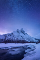 Wall Mural - Otertind mountain, Lyngen Alps, Norway. Natural andscape. Starry sky and moon light. Long exposure photography in the mountain region. Winter night landscape with starry sky.