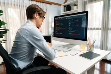IT developer looking at online software development information on pc align working laptop with coding program on updated version application project trial creating new code overall system. Pecuniary.