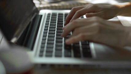 Programmer's hands and laptop keyboard close-up