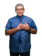 © Krakenimages.com - Handsome senior business man over isolated background smiling with hands on chest with closed eyes and grateful gesture on face. Health concept.