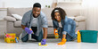 © Prostock-studio - Household Chores Concept. Smiling black couple washing floor in their apartment with detergent spray and rag, making spring cleaning together
