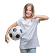 © Krakenimages.com - Young beautiful girl holding soccer football ball over isolated background with surprise face pointing finger to himself