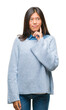© Krakenimages.com - Young asian woman wearing winter sweater over isolated background with hand on chin thinking about question, pensive expression. Smiling with thoughtful face. Doubt concept.