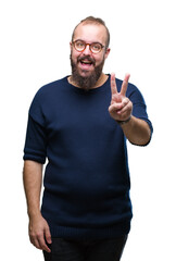 Wall Mural - Young caucasian hipster man wearing sunglasses over isolated background smiling with happy face winking at the camera doing victory sign. Number two.