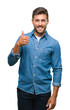 © Krakenimages.com - Young handsome man over isolated background doing happy thumbs up gesture with hand. Approving expression looking at the camera with showing success.