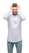 © Krakenimages.com - Young handsome man over isolated background suffering from headache desperate and stressed because pain and migraine. Hands on head.