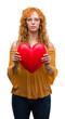 © Krakenimages.com - Young redhead woman in love holding red heart with a confident expression on smart face thinking serious
