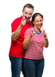 © Krakenimages.com - Middle age hispanic couple in love over isolated background pointing fingers to camera with happy and funny face. Good energy and vibes.