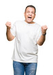 © Krakenimages.com - Middle age arab man wearig white t-shirt over isolated background celebrating surprised and amazed for success with arms raised and open eyes. Winner concept.