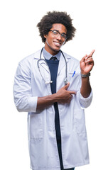 Wall Mural - Afro american doctor man over isolated background with a big smile on face, pointing with hand and finger to the side looking at the camera.