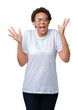 © Krakenimages.com - Beautiful young african american woman wearing glasses over isolated background celebrating mad and crazy for success with arms raised and closed eyes screaming excited. Winner concept