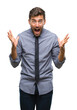 © Krakenimages.com - Young handsome business man over isolated background celebrating crazy and amazed for success with arms raised and open eyes screaming excited. Winner concept