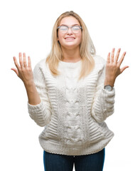 Wall Mural - Young caucasian woman wearing glasses over isolated background celebrating mad and crazy for success with arms raised and closed eyes screaming excited. Winner concept