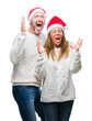 © Krakenimages.com - Middle age hispanic couple wearing christmas hat over isolated background celebrating mad and crazy for success with arms raised and closed eyes screaming excited. Winner concept