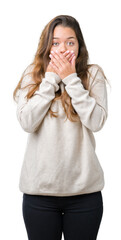 Wall Mural - Young beautiful brunette woman wearing turtleneck sweater over isolated background shocked covering mouth with hands for mistake. Secret concept.