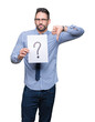 © Krakenimages.com - Handsome young business man holding paper with question mark over isolated background with angry face, negative sign showing dislike with thumbs down, rejection concept