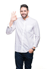 young business man over isolated background smiling positive doing ok sign with hand and fingers. su